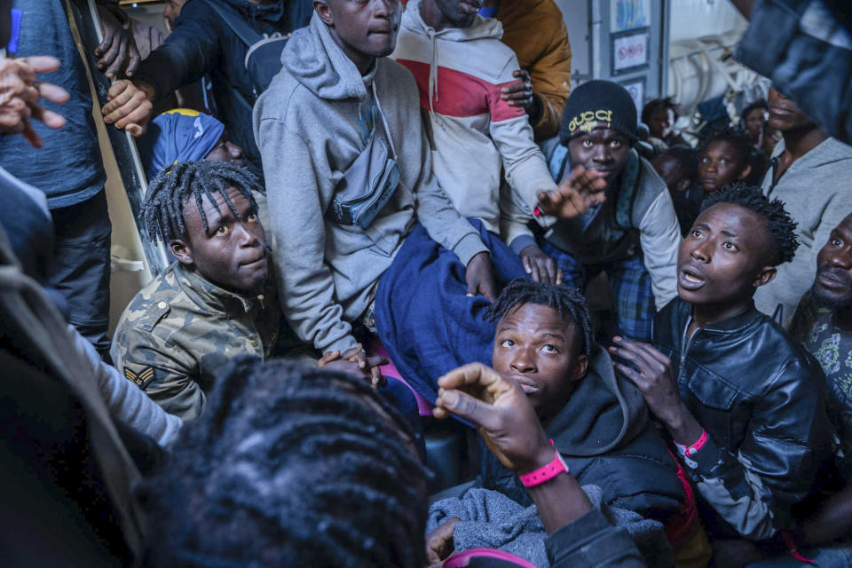 Migrants on the deck of the Rise Above rescue ship run by the German organization Mission Lifeline, in the Mediterranean Sea off the coasts of Sicily, southern Italy, Sunday, Nov. 6, 2022. Italy allowed one rescue ship, the German run Humanity 1, to enter the Sicilian port and begin disembarking minors, but refused to respond to requests for safe harbor from three other ships carrying 900 more people in nearby waters. (Severine Kpoti/Mission Lifeline Via AP)