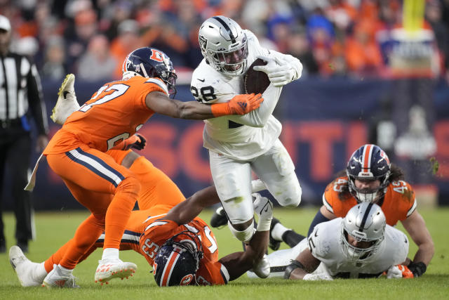 Las Vegas Raiders running back Josh Jacobs (28) stiff arms New