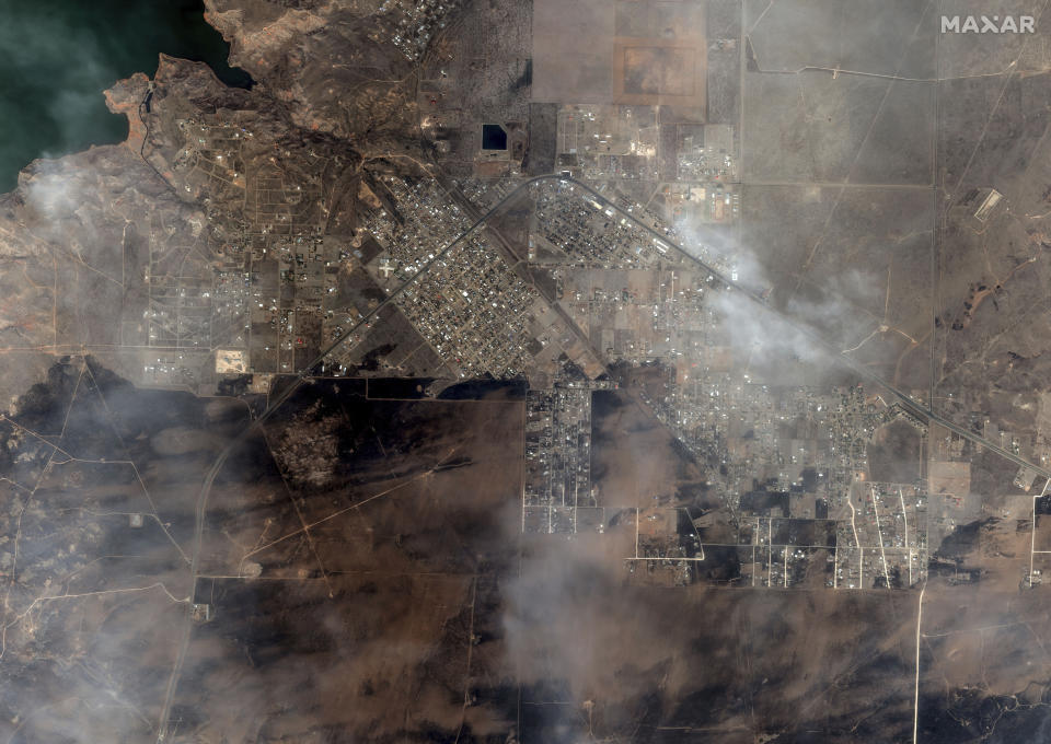 This satellite image provided by Maxar Technologies shows an overview of burned areas with clouds above after the wildfires in the town of Fritch, Texas, Wednesday, Feb. 28, 2024. A cluster of wildfires is scorching the Texas Panhandle, including a blaze that grew into one of the largest in state history. The flames blackened the landscape across a vast stretch of small towns and cattle ranches. (Maxar Technologies via AP)