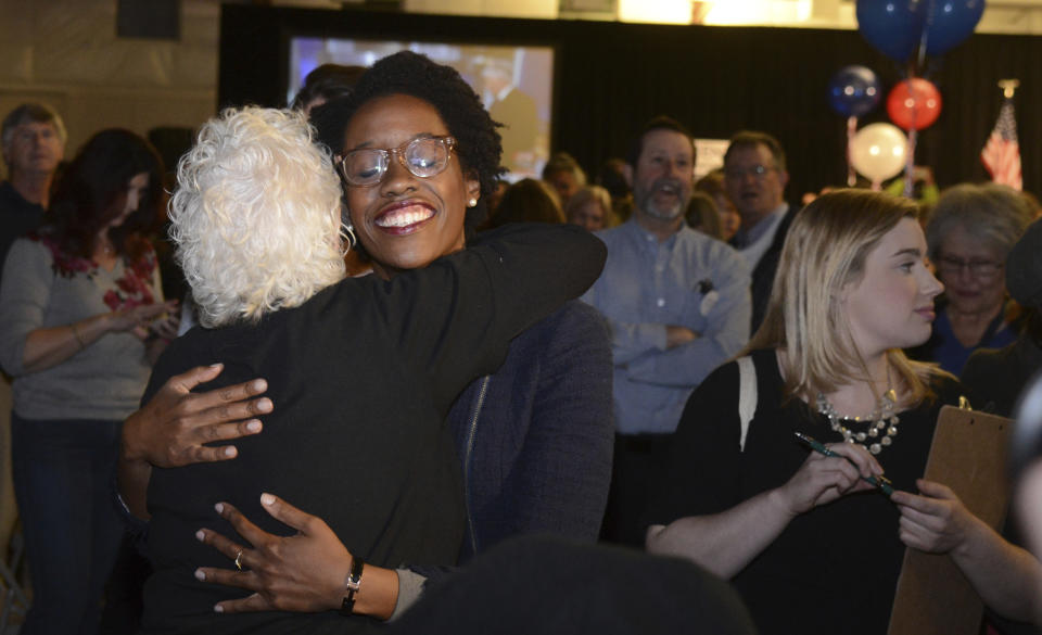 FILE - In this Nov. 6, 2018 file photo, Illinois candidate for the 14th congressional district Lauren Underwood visits with others at her election night party in St. Charles, Ill. on Tuesday, Nov. 6, 2018. Illinois Democrats did what was once unthinkable when they flipped two suburban Chicago congressional districts that had been held by Republicans pretty much since World War II. Underwood unseated four-term Republican Rep. Randy Hultgren. (Rick West/Daily Herald via AP)