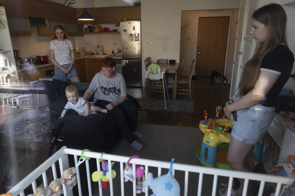 Taisiia Mokrozub, left, her son Hordii, second left, Taisiia's mother Svitlana Syzovab, second right, and niece Victoria, right, take part in an interview with The Associated Press in a flat in Pruszkow, Poland, Wednesday, Aug. 17, 2022. As Russia’s war against Ukraine reaches the sixth-month mark, many refugees are coming to the bitter realization that they will not be returning home soon. With shelling around a nuclear power plant and missiles threatening even western regions of Ukraine, many refugees don’t feel safe at home, even if those areas are under Ukrainian control. (AP Photo/Michal Dyjuk)