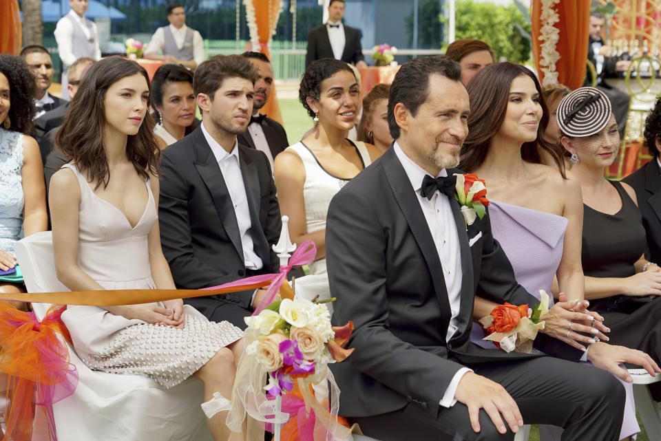 This image provided by ABC shows Denyse Tontz, left, Bryan Craig, second from left, Demian Bichir, front, and Roselyn Sanchez in a scene from the network's series "Grand Hotel." Eva Longoria executive produces this drama set at the last family-owned hotel in Miami Beach. (Eric McCandless/ABC via AP)