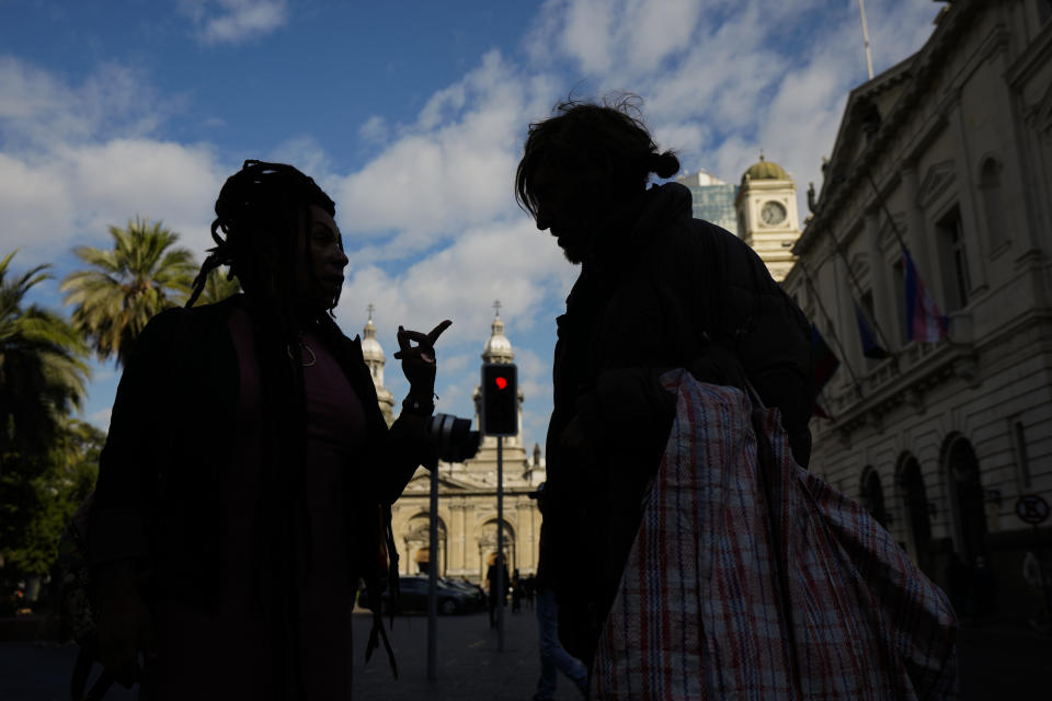 Homeless person Paris Lopez, right, talks with a member of the NGO Diverse Action before they meet with a city council member in Santiago, Chile, Monday, April 29, 2024. Lopez, a Chilean trans woman, is meeting with the city worker to complain that police confiscate her tent and blankets, as well as her HIV medication, while she sleeps in public spaces. (AP Photo/Esteban Felix)