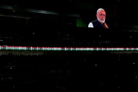 India's Prime Minister Narendra Modi is seen ona large screen as he takes part in an event at Wembley Stadium, in London, November 13, 2015. REUTERS/Suzanne Plunkett