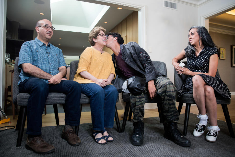 Michael Matt kisses his mother, Judy, while waiting to be interviewed on camera by reporter Lisa Belkin (out of frame) for Yahoo News, on June 23, 2018, in Providence, R.I. From left: Andrew Matt, Judy Matt, Michael Matt, Gina Aparicio. (Photo: Kayana Szymczak for Yahoo News)