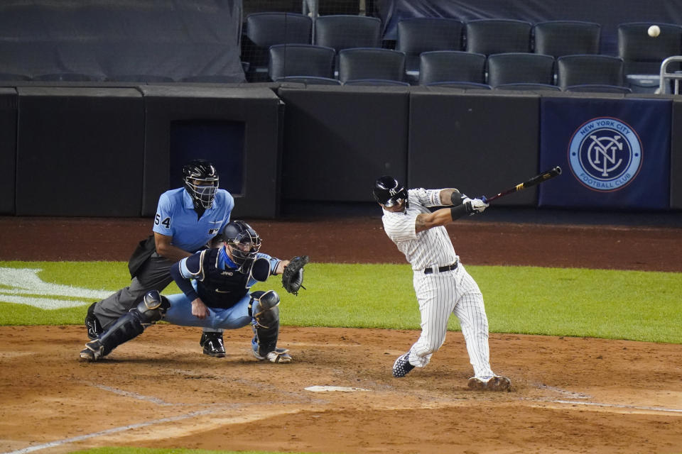 New York Yankees' Gleyber Torres hits a home run during the fourth inning of a baseball game as Toronto Blue Jays catcher Danny Jansen watches Thursday, Sept. 17, 2020, in New York. (AP Photo/Frank Franklin II)