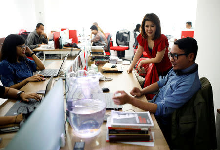 The leader of the Indonesian Solidarity Party (PSI), Grace Natalie (2ndR), chats with staff at the party's headquarters in Jakarta, Indonesia March 19, 2018. REUTERS/Darren Whiteside