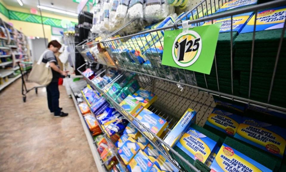 person shopping at a dollar store with sign for $1.25 product in the foreground