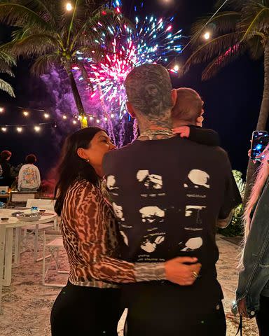 <p>Kourtney Kardashian/Instagram</p> Kourtney Kardashian, Travis Barker and son Rocky watching fireworks