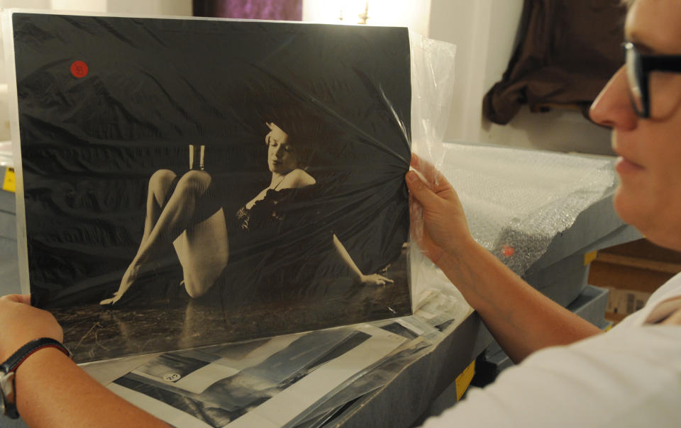 Photo gallery curator Anna Wolska presents a photo of Marylin Monroe by the late celebrity photographer Milton H. Greene, in Warsaw, Poland. (AP Photo/Alik Keplicz)