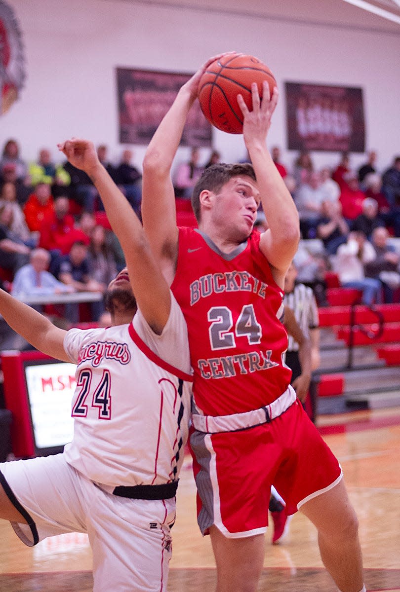 Buckeye Central's Jack Phillips grabs a rebound away from Bucyrus' Tyrone Mass.