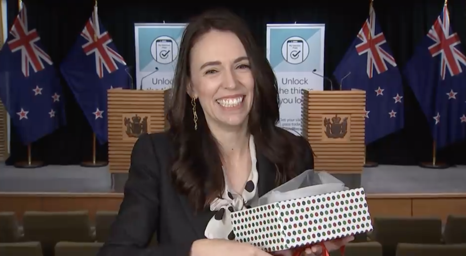 Jacinda Ardern opens up a Christmas present on TVNZ Breakfast.