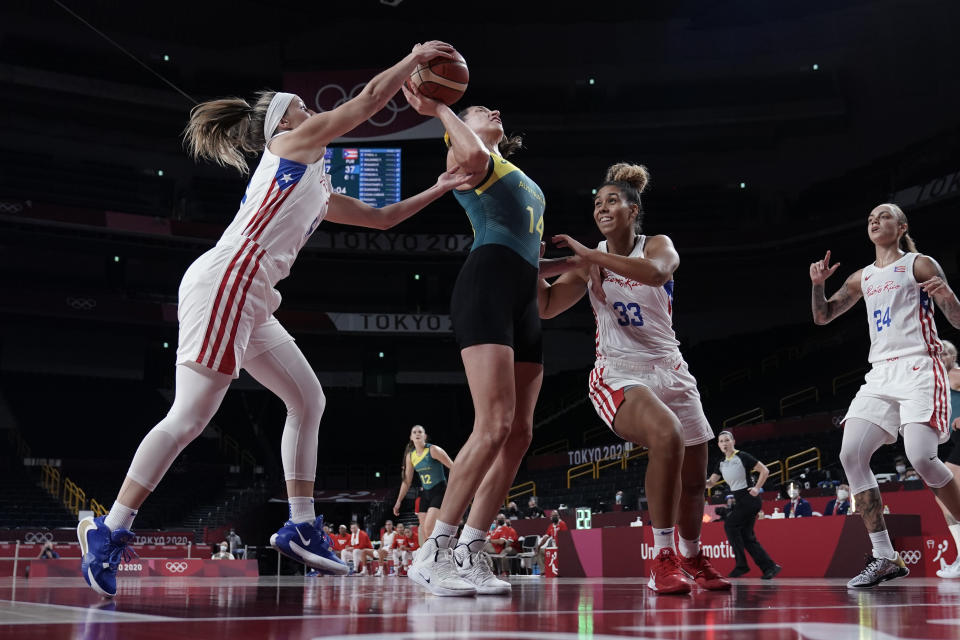 Australia's Marianna Tolo (14) is blocked by Puerto Rico's Ali Gibson, left, during a women's basketball game at the 2020 Summer Olympics, Monday, Aug. 2, 2021, in Saitama, Japan. (AP Photo/Eric Gay)