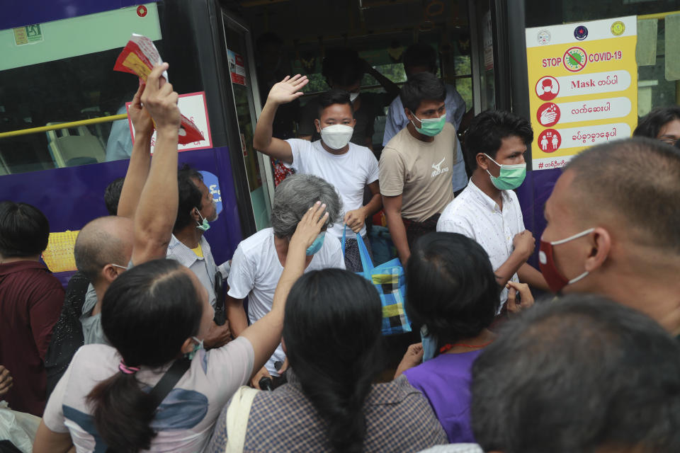 Detainees wave from a bus after a mass-prisoner release from the Insein Prison Tuesday, Oct. 19, 2021, in Yangon, Myanmar. Myanmar's government on Monday announced an amnesty for thousands of prisoners arrested for taking part in anti-government activities following February's seizure of power by the military. (AP Photo)