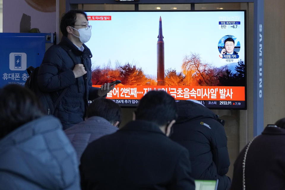 People watch a TV showing a file image of North Korea's missile launch during a news program at the Seoul Railway Station in Seoul, South Korea, Tuesday, Jan. 11, 2022. North Korea on Tuesday fired what appeared to be a ballistic missile into its eastern sea, its second weapons launch in a week, the militaries of South Korea and Japan said. The Korean letters read "North Korea launched a hypersonic missile last time." (AP Photo/Ahn Young-joon)