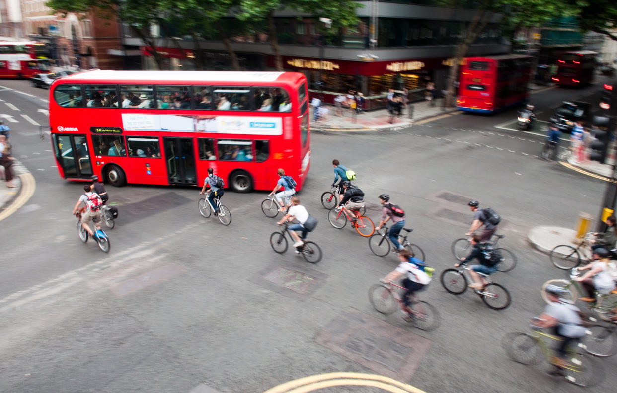 London, England - July 5, 2011: Commuter cyclists set off from a green light at a busy road junction in Central London.