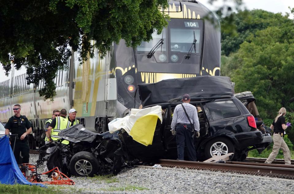 Broward Sheriff's Deputies and Pompano Beach Fire Rescue work the scene of a fatal accident Aug. 25, 2019, on North Dixie Highway in Pompano Beach.  The Florida higher-speed passenger train service tied to Richard Branson's Virgin Group has the worst per-mile death rate in the U.S. The first death involving a Brightline train happened in July 2017 during test runs. An Associated Press analysis of Federal Railroad Administration data shows that since then, 40 more have been killed. That amounts to a rate of more than one a month and about one for every 29,000 miles the trains have traveled since the first death.