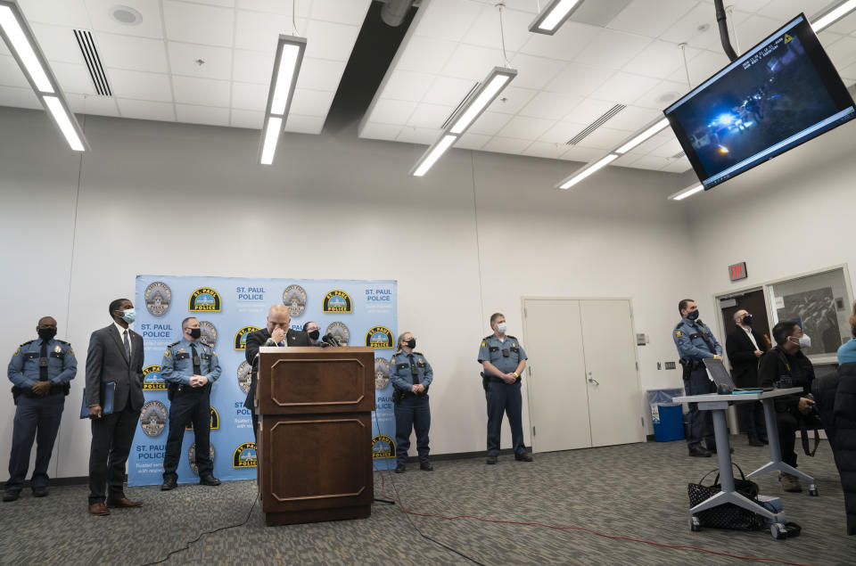 St. Paul Police Chief Todd Axtell, Mayor Melvin Carter, and other officers stood at the podium as body camera footage played for the media on televisions in the room at a press conference about a shooting by a police officer last weekend in St. Paul, Minn., on Tuesday, Dec. 1, 2020. (Renee Jones Schneider/Star Tribune via AP)