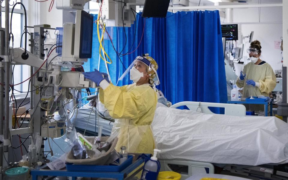  nurses caring for Covid-19 patients in the Intensive Care Unit (ICU) in St George's Hospital in Tooting, south-west London. Half of the coronavirus patients admitted to hospital during the first wave developed at least one complication, new research has found. Issue date: Thursday July 15, 2021. PA Photo. The study included more than 70,000 adults in the UK admitted to hospital with severe Covid-19 disease. Of these, half (36,367 of 73,197) developed one or more health complications during their stay.See PA story HEALTH Coronavirus. - AP