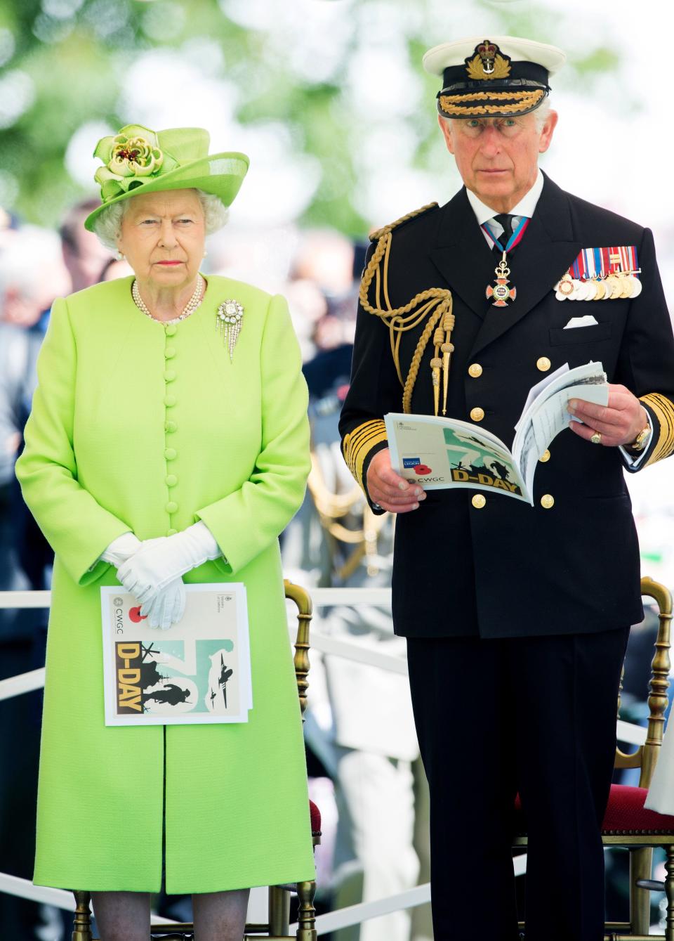 Queen Elizabeth and King Charles (then Prince Charles) stand together at a D-Day anniversary event in 2014