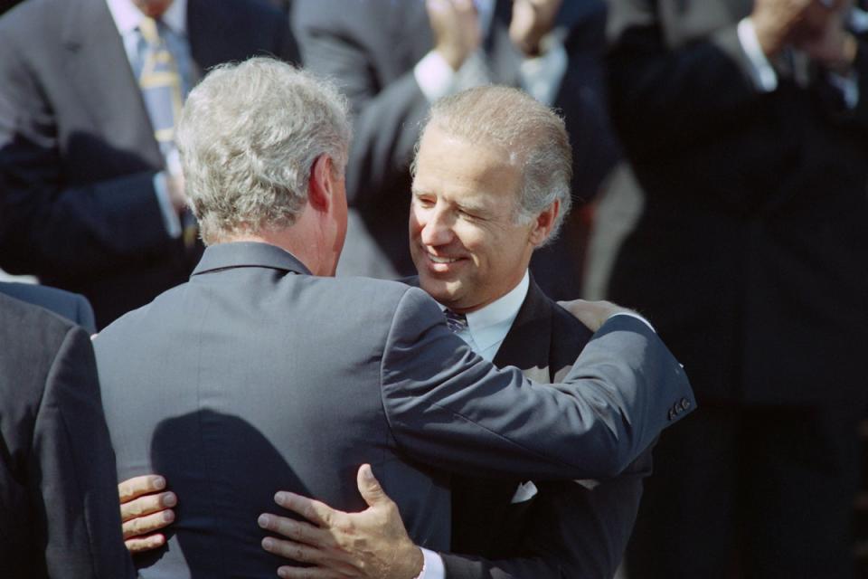 Then-Senator Joe Biden hugs then-President Bill Clinton during a signing ceremony for the 1994 crime bill. (AFP via Getty Images)