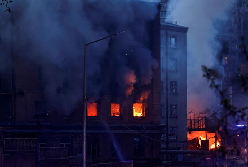 Fire burns in a building after a shelling, amid Russia's invasion of Ukraine, in Kyiv.