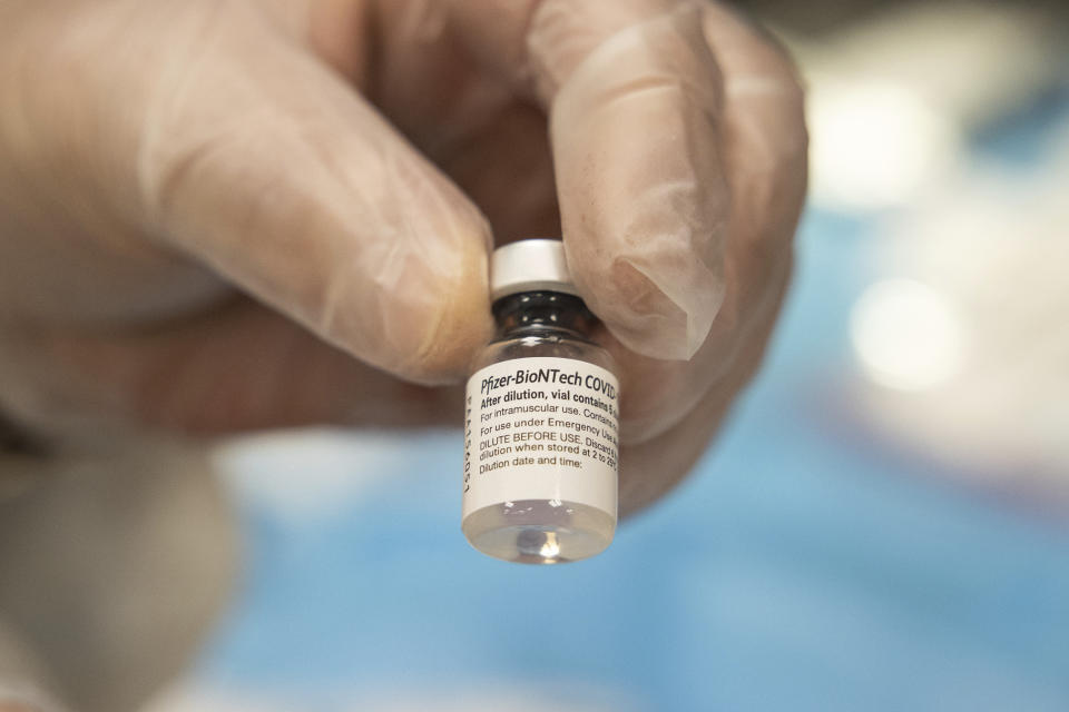 CVS Pharmacist Gerard Diebner shows the COVID-19 vaccine at Harlem Center for Nursing and Rehabilitation, a nursing home facility, on Friday, Jan. 15, 2021 in Harlem neighborhood of New York. (AP Photo/Yuki Iwamura)