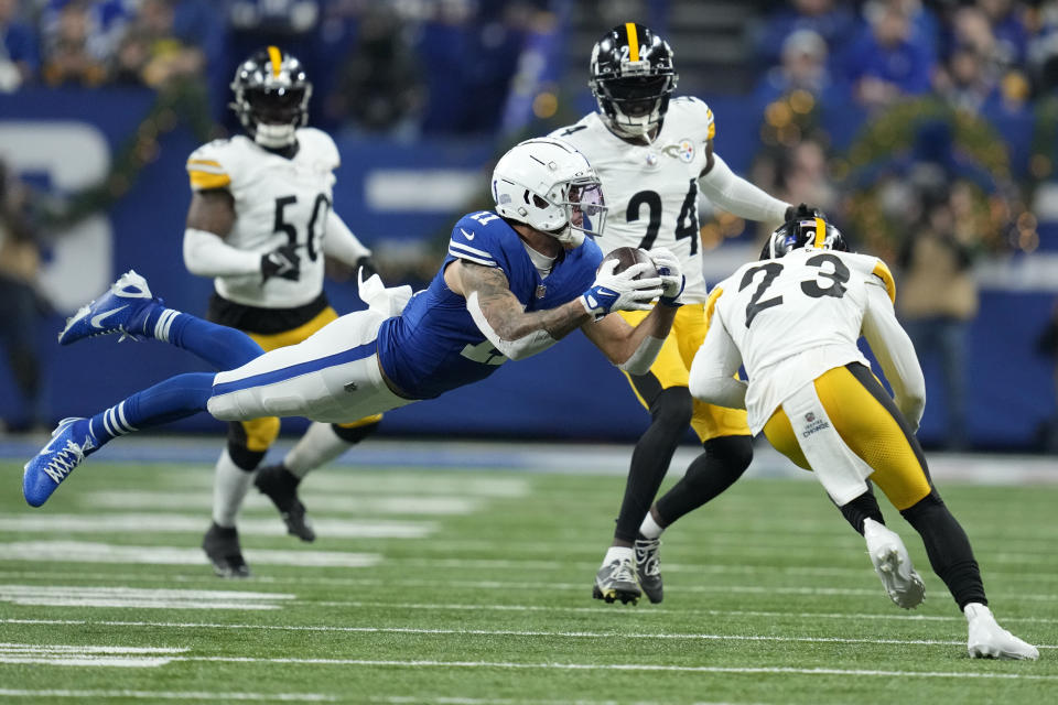 Indianapolis Colts wide receiver Michael Pittman Jr. (11) catches a pass before being hit by Pittsburgh Steelers safety Damontae Kazee (23) during the first half of an NFL football game in Indianapolis Saturday, Dec. 16, 2023. Pittman was injured on the play and Kazee was ejected from the game. (AP Photo/Michael Conroy)