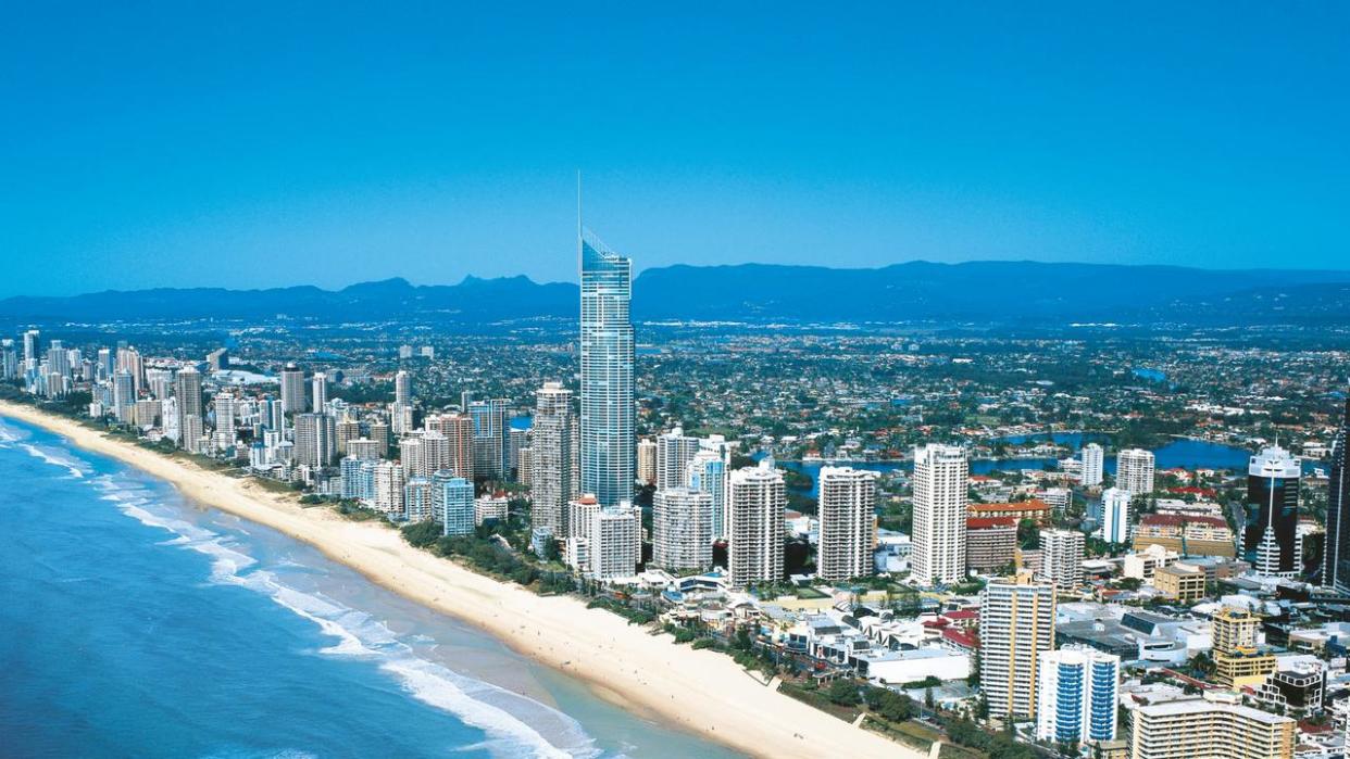 A woman has plunged to her death from a Gold Coast balcony overnight following a suspected medical episode.