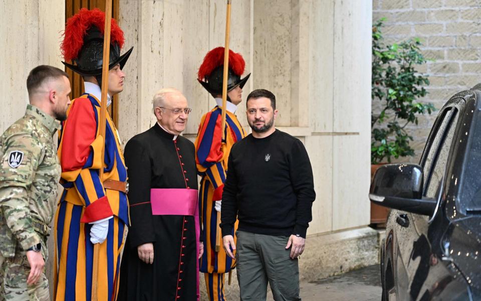 Ukrainian President Volodymyr Zelensky is welcomed by Prefect of the Pontifical House, Monsignor Leonardo Sapienza as he arrives at the Vatican for his meeting with the Pope - Andreas Solaro/AFP