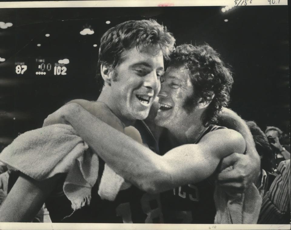 Dave Cowens (left) and John Havlicek celebrate the 1974 NBA championship at the Milwaukee Arena.