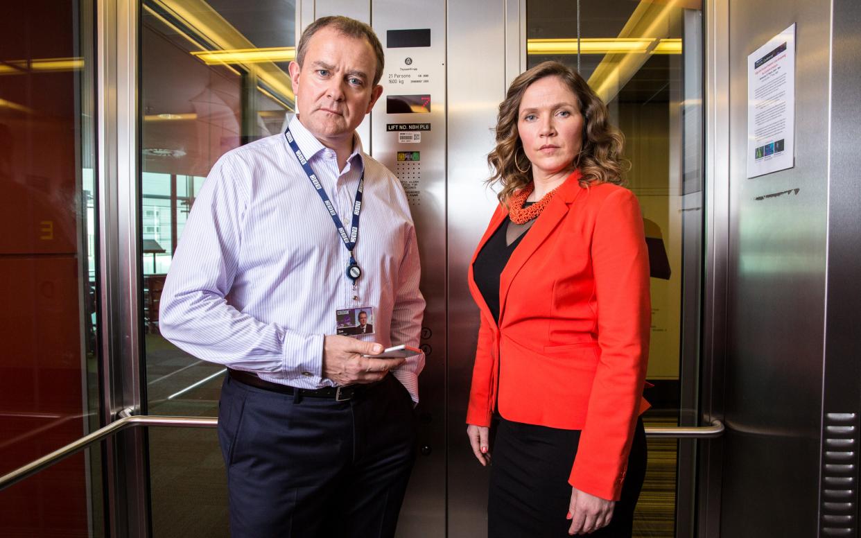 Ian Fletcher (Hugh Bonneville) and Siobhan Sharpe (Jessica Hynes) in W1A - WARNING: Use of this copyright image is subject to the terms of use of BBC Pictures' Digital Picture Service (BBC Pictures) as set out at www.bbcpictures.co.uk. In particular, this image may only be published by a registered User of BBC Pictures for editorial use for the purpose of publicising the relevant BBC programme, personnel or activity during the Publicity Period which ends three review weeks following the date of transmission and provided the BBC and the copyright holder in the caption are credited. For any other purpose whatsoever, including advertising and commercial, prior written approval from the copyright holder will be required.