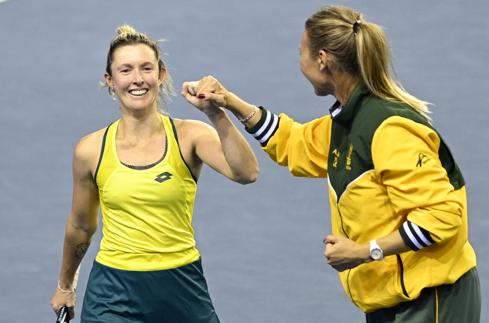 From left to right, Storm Sanders celebrates with Australia captain Alicia Molik after her victory against England in the Billie Jean King Cup.