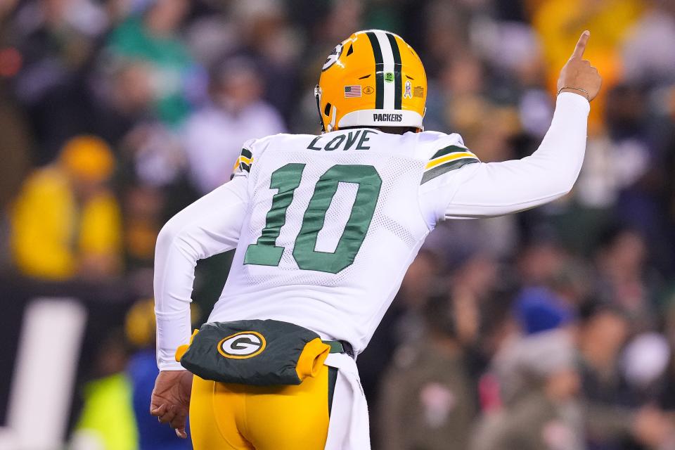 Jordan Love of the Green Bay Packers celebrates after throwing a touchdown pass to Christian Watson during a game against the Philadelphia Eagles last season. He came in for an injured Aaron Rodgers.