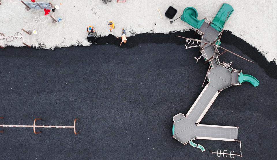 Workers prepare the playground base during construction in March 2024 at Olentangy Local Schools' new Peachblow Crossing Elementary.