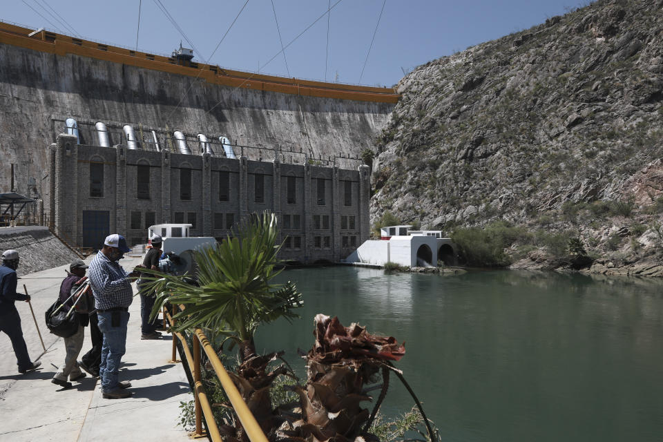 Farmers stand at La Boquilla Dam, where they wrested control on Tuesday from National Guard troops in order to close the valves and reduce the flow of water toward the United States, in Chihuahua State, Wednesday, Sept. 9, 2020. Tuesday's clash between hundreds of farmers and National Guard troops was the latest flashpoint in a months-long conflict over the Mexican government's attempts to pay off its water debt with the United States over objections of local farmers. (AP Photo/Christian Chavez)