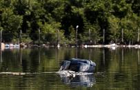 A sofa is seen in the Guanabara Bay in Rio de Janeiro March 12, 2014. REUTERS/Sergio Moraes