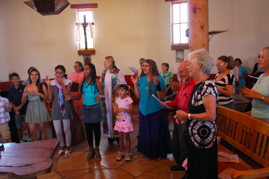 Rev. Alison Harrington (center, in white robe) leading her congregation in worship at Southside Presbyterian Church in Tucson, Arizona, in 2013.