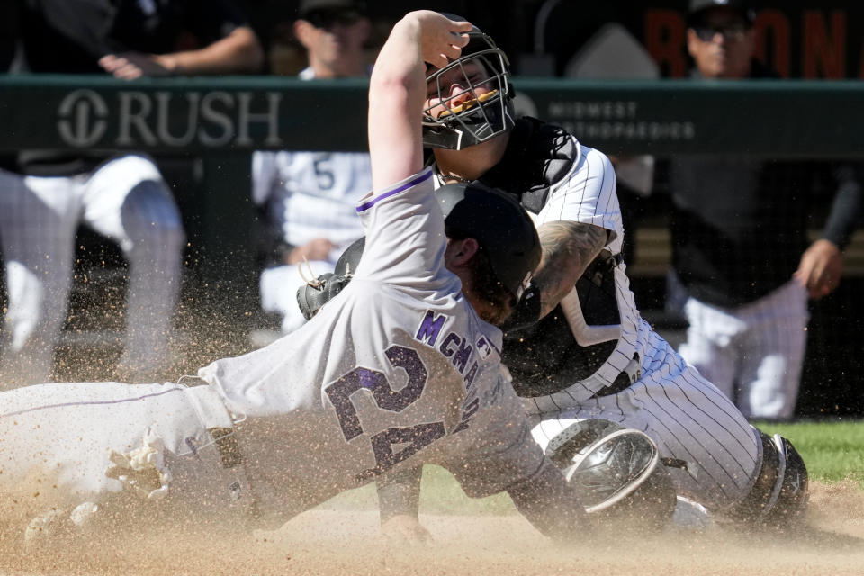 Colorado Rockies' Ryan McMahon (24) scores on a sacrifice fly by Michael Toglia as Chicago White Sox catcher Martín Maldonado, top, applies a late tag during the 14th inning of a baseball game in Chicago, Sunday, June 30, 2024. (AP Photo/Nam Y. Huh)