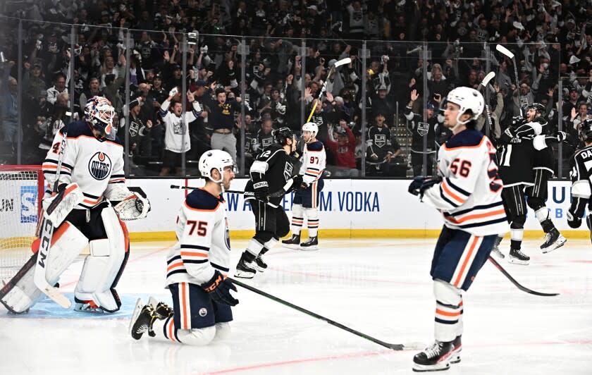 Kings players celebrate the tying goal against the Oilers late in the third period in game six