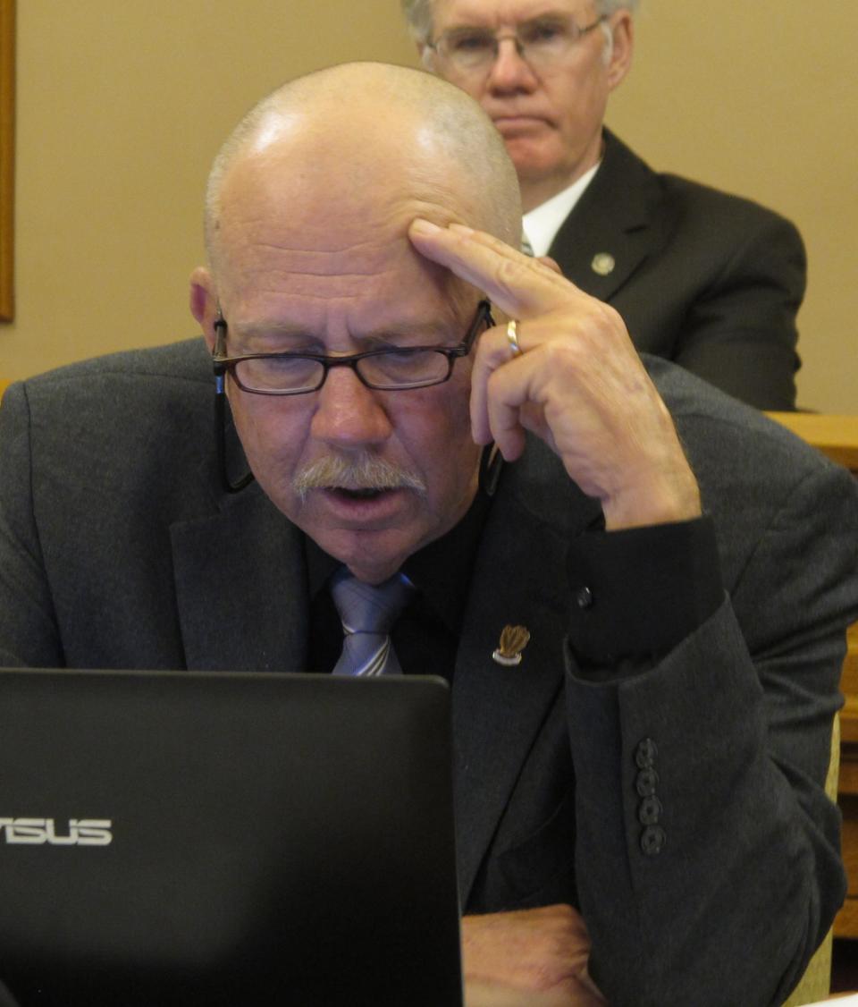 Kansas state Rep. Nile Dillmore, a Wichita Democrat, considers new projections for how a plan to cut sales and income taxes will affect the state budget, Monday, April 30, 2012, at the Statehouse in Topeka, Kan. Kansas legislators who are pushing for income tax cuts said Monday they're willing to tinker with their latest plan to avoid a budget shortfall and address a big concern of a bipartisan group already skeptical of the proposal. (AP Photo/John Hanna)