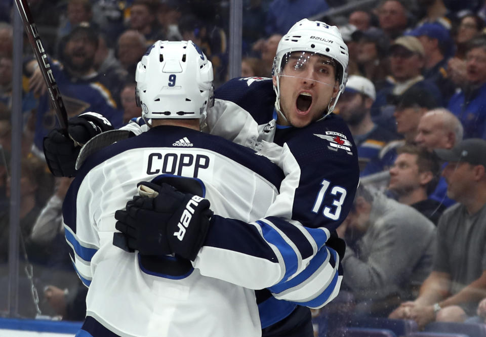 Winnipeg Jets' Brandon Tanev (13) is congratulated by teammate Andrew Copp after scoring during the third period in Game 3 of an NHL first-round hockey playoff series against the St. Louis Blues, Sunday, April 14, 2019, in St. Louis. The Jets won 6-3. (AP Photo/Jeff Roberson)