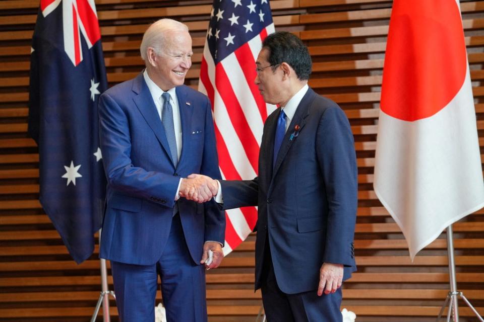 Japanese prime minister Fumio Kishida welcomes US president Joe Biden in Tokyo on 24 May (Reuters)
