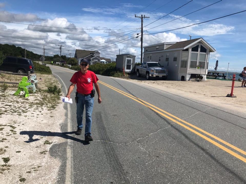 Ken Nickelson, of the Westport Fire Department, hands out notices to evacuate the area should the hurricane watch status of Henri be escalated to a warning in this 2021 Herald News file photo.