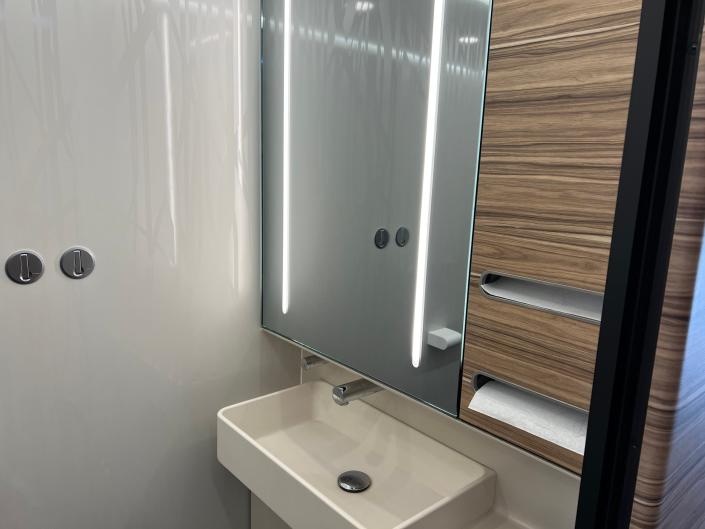 Train car bathroom with mirror and sink