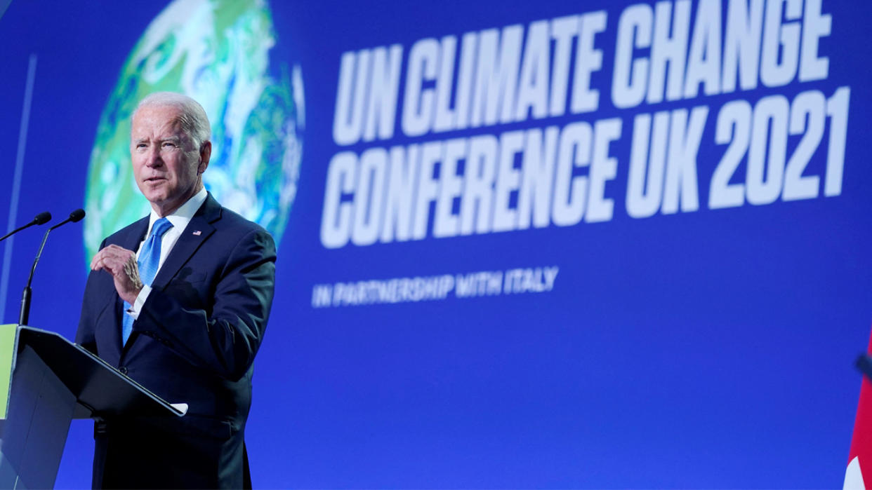 President Biden stands at a podium and gives a speech at the United Nations Climate Change Conference in Glasgow, Scotland.