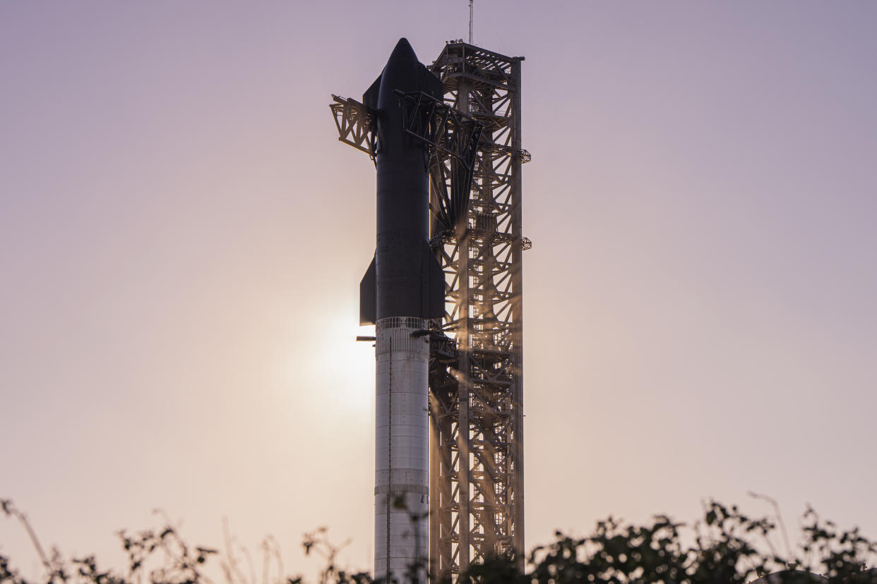  A sleek SpaceX Starship on its booster and launch pad. 