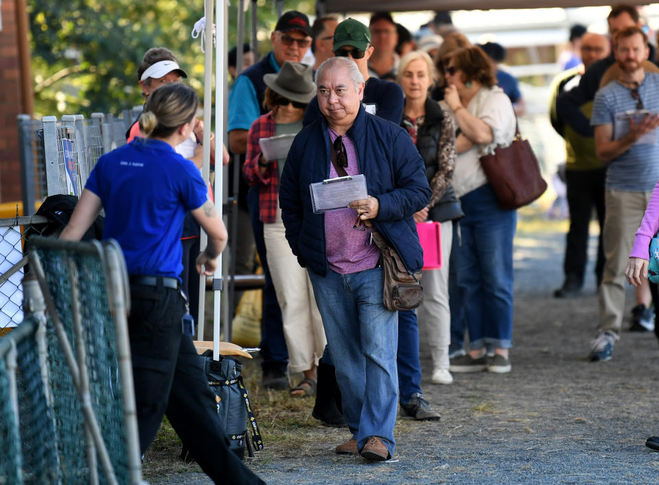 People line up to receive a coronavirus vaccination at the Rocklea Showgrounds in Brisbane. Source: AAP