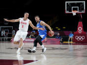 Czech Republic's Jakub Sirina, right, drives the ball around Iran's Pujan Jalalpoor during men's basketball game at the 2020 Summer Olympics, Sunday, July 25, 2021, in Saitama, Japan. (AP Photo/Charlie Neibergall)