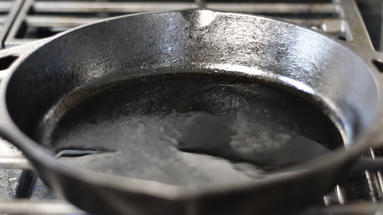Cast iron skillet heating on stovetop